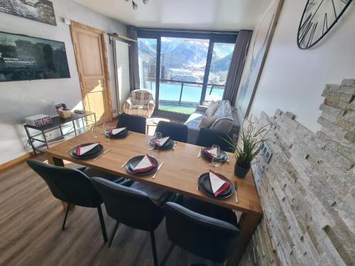 a dining room table and chairs in a living room at Vanoise C in La Daille