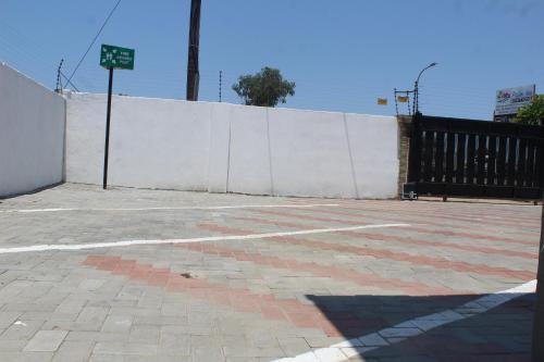 an empty parking lot next to a white fence at Palm Inn Boutique guest house in Francistown