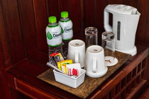 a shelf with a coffee maker and drinks on it at Saem Siemreap Hotel in Siem Reap