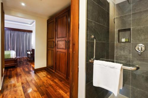 a bathroom with a walk in shower and a towel at Saem Siemreap Hotel in Siem Reap