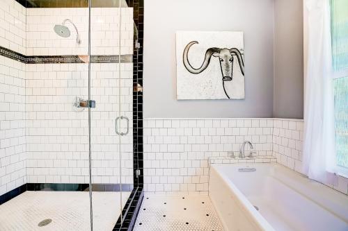 a bathroom with a shower and a painting of a ram at Garden Home in Austin