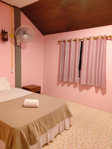 a bedroom with a bed with a towel on it at Garden View Resort Tonsai in Tonsai Beach