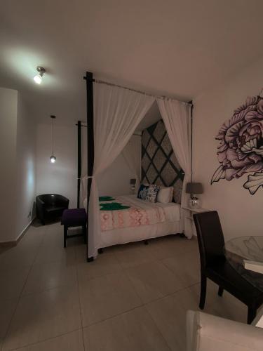 a bedroom with a bed with a canopy at Hotel Maya Jade in Monterrico