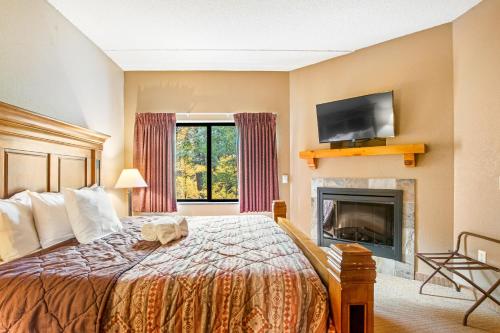 a hotel room with a bed and a fireplace at Chula Vista Condo 2251 in Wisconsin Dells