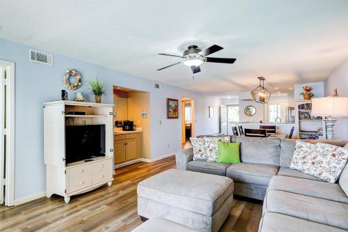 a living room with a couch and a tv at Mariners Cay 23 in Folly Beach