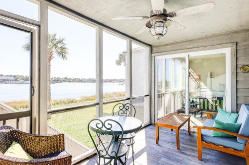 a porch with a table and chairs and a view of the water at Mariners Cay 23 in Folly Beach