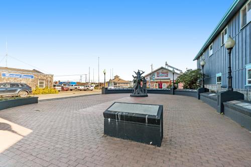 a bench in the middle of a brick walk way at Little Ocean in Ocean Park