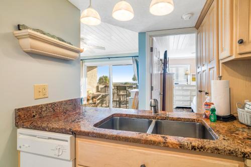 a kitchen with a sink and a large window at Sand Dollar Villas 109 in Fernandina Beach