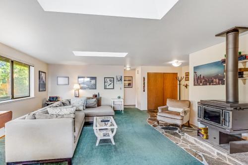 a living room with a couch and a fireplace at North Hood Canal House in Hansville