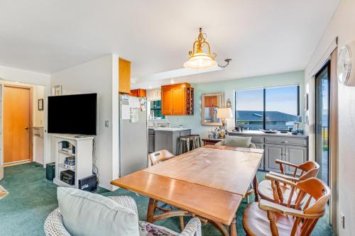 a kitchen and dining room with a wooden table and chairs at North Hood Canal House in Hansville
