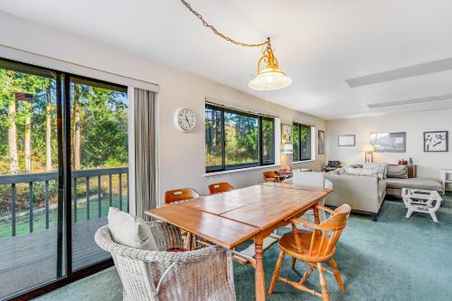 a living room with a wooden table and chairs at North Hood Canal House in Hansville
