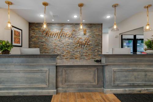 a bar in a restaurant with a brick wall at Best Western Plus Rumford Falls in Rumford