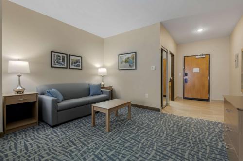 a living room with a couch and a table at Best Western Plus Rumford Falls in Rumford
