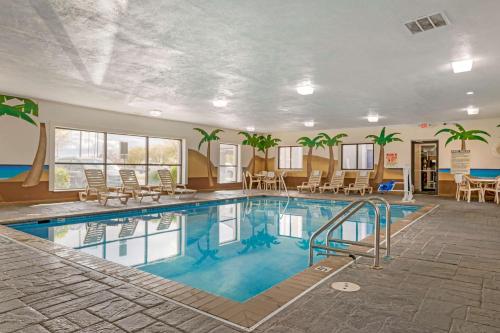 a pool in a hotel with chairs and tables at Best Western Edinburgh/Columbus in Edinburgh