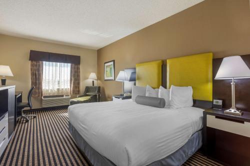 a hotel room with a large bed and a television at Best Western Plus Searcy Inn in Searcy