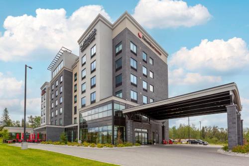a large building with a bridge in front of it at Best Western Premier Northwood Hotel in Timmins