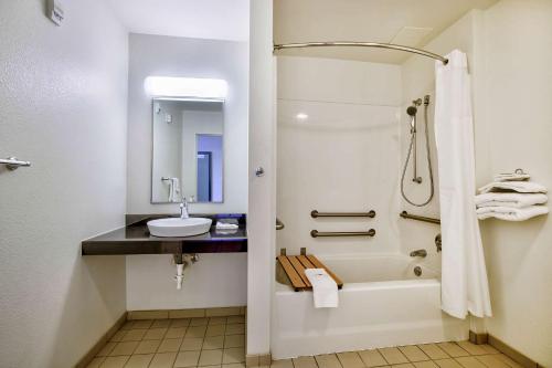 a bathroom with a tub and a sink and a shower at Motel 6-Duluth, MN in Duluth