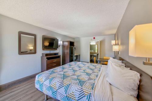 a bedroom with a bed and a flat screen tv at Studio 6 Birmingham, AL - Medical Center - Inverness Hwy 280 in Birmingham