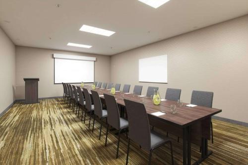 a conference room with a long table and chairs at Sonesta Select Atlanta Norcross I 85 in Norcross