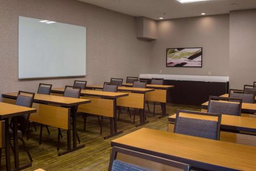 a classroom with tables and chairs and a whiteboard at Sonesta Select Atlanta Norcross I 85 in Norcross