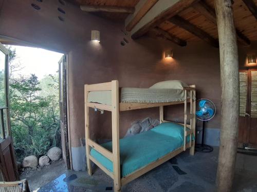 a bedroom with two bunk beds in a room at Ecohostel Tay Pichin in San Marcos Sierras