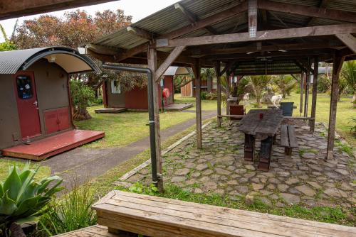 a picnic table under a pavilion in a park at Solscape in Raglan