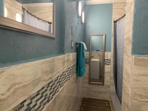 La salle de bains est pourvue d'une douche à l'italienne et d'un miroir. dans l'établissement Michaels Surfside Cabanas, à Clearwater Beach