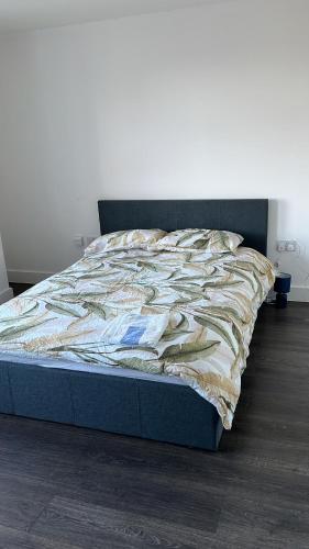 a bed sitting in a bedroom with a blanket on it at The Serviced Accommodations in Harlow