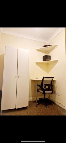 an office with a desk and a chair next to a cabinet at Ensuite Private room Furzehill road in Plymouth