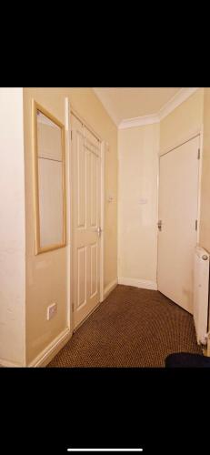 an empty room with an open door and a hallway at Ensuite Private room Furzehill road in Plymouth