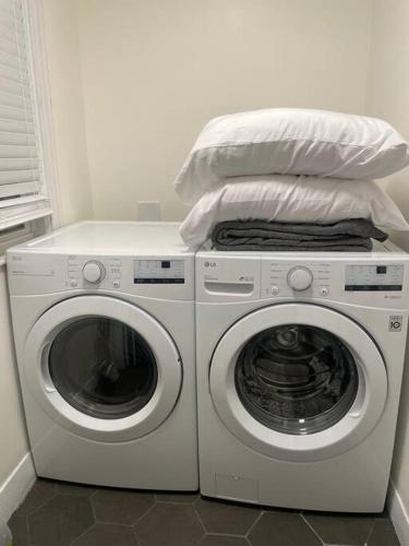 a laundry room with a washer and a dryer at Modern Three Bedroom Condo - Boston in Stoneham