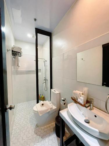 a bathroom with a sink and a toilet and a shower at Patio by Balai Norte in San Juan