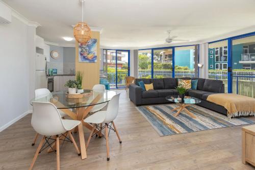 a living room with a couch and a table at Heritage 103 in Tuncurry