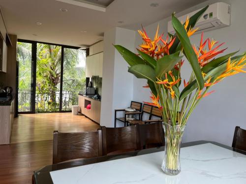 a vase of flowers on a table in a living room at Friendly villa SH Đại Lải 4 phòng ngủ in Phúc Yên