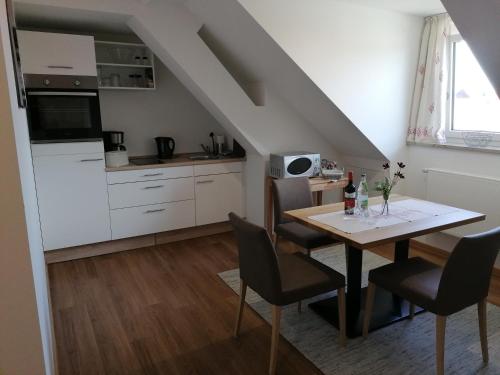 a kitchen and dining room with a table and chairs at Pension zum Bären in Langerringen