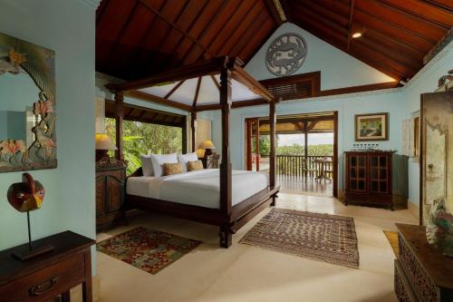 a bedroom with a canopy bed in a room at Villa Inka Ubud by Nakula in Ubud