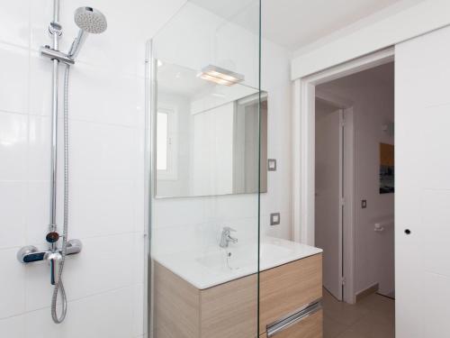 a bathroom with a sink and a glass shower at Resort, Corralejo in Corralejo