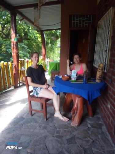 a man and a woman sitting at a table at Beach cabin ometepe in Altagracia