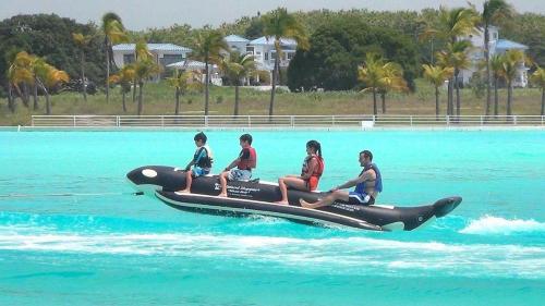 a group of people riding on a jet ski in the water at Playa Blanca Ocean in Río Hato