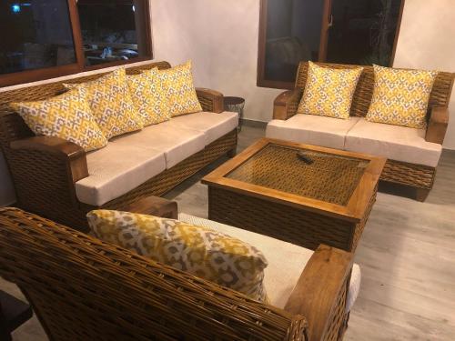 a living room with couches and chairs and a table at Villa Mi Patio By Hospedify - Hermosa villa con mesa de billar y río cristalino a 3 min Un pequeño paraíso en Jarabacoa in Jarabacoa