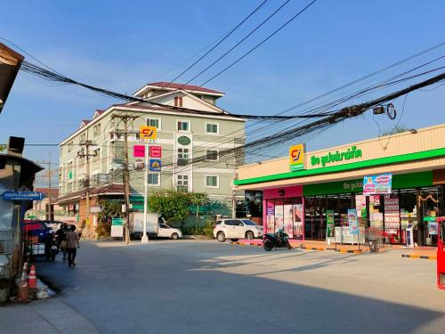 an empty street in a city with buildings at Tisaraporn Resident in Ban Khlong Song (1)