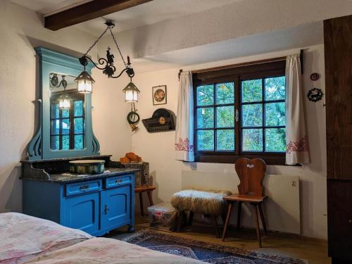 a bedroom with a blue stove and a window at Holiday home in Edlitz in Wechselland with sauna in Edlitz