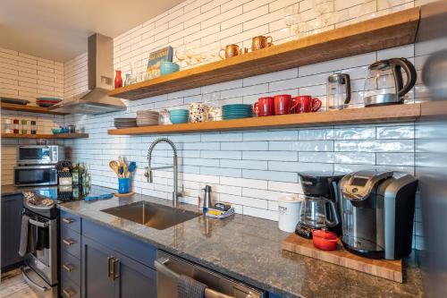 a kitchen with a sink and a counter top at Fully Renovated Ski-in/out Loft with Private Hot Tub! in Golden