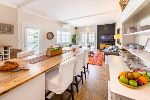 a kitchen and living room with a large wooden counter top at The Edward Townhouses 151 - 157 in Orange