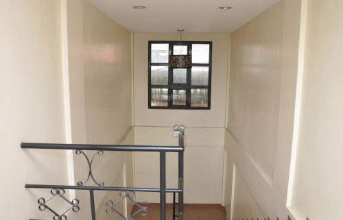 a stairwell with a window and a stair railing at Pal-Watson Apartments in Mactan