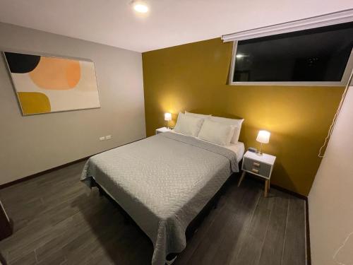 a small bedroom with a bed and a flat screen tv at Hotel Villas Santander in Guatemala