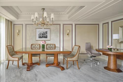 a dining room with a table and chairs at The Fullerton Hotel Singapore in Singapore