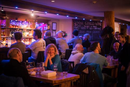 a group of people sitting at tables in a restaurant at Fully Renovated Ski-in/out Loft with Private Hot Tub! in Golden