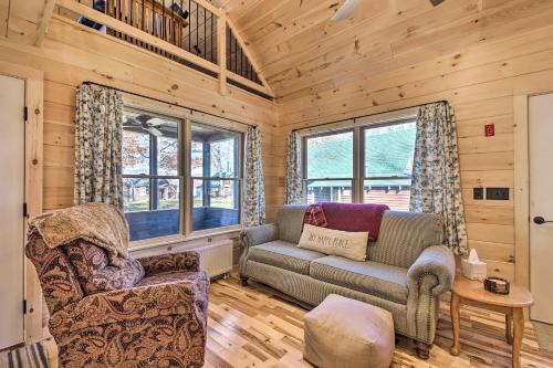 a living room with a couch and a chair at Inviting Webb Lake Cabin with Mountain Views in Weld