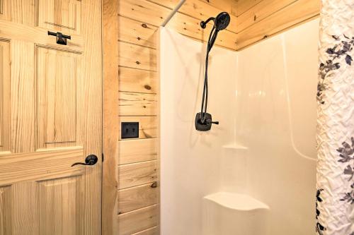a bathroom with a shower and a door at Inviting Webb Lake Cabin with Mountain Views in Weld